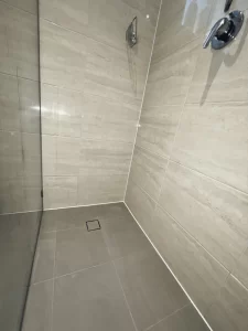 Shower looking brand new after wall and floor tiles have had old grout removed and new grout installed.