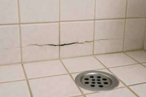 Cracked grout and tiles in shower