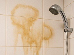 Tiles on bathroom wall stained by water