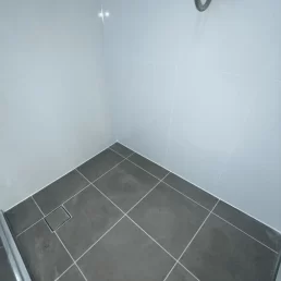 A photo showing how the shower looks new after old grout has been removed and new grout installed.