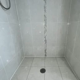 Tiles looking brand new in shower after old grout has been removed and new grout installed.