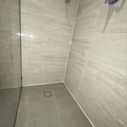 Shower looking brand new after wall and floor tiles have had old grout removed and new grout installed.