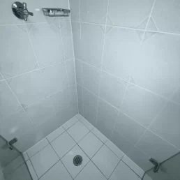 The same shower looking brand new after old grout has been removed and new grout applied.